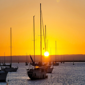Image by flaminilee titled ’sunset, sailboats, sea’. Source: Pixabay